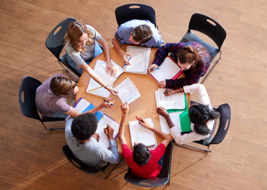 A group of students sitting together and working on their school work