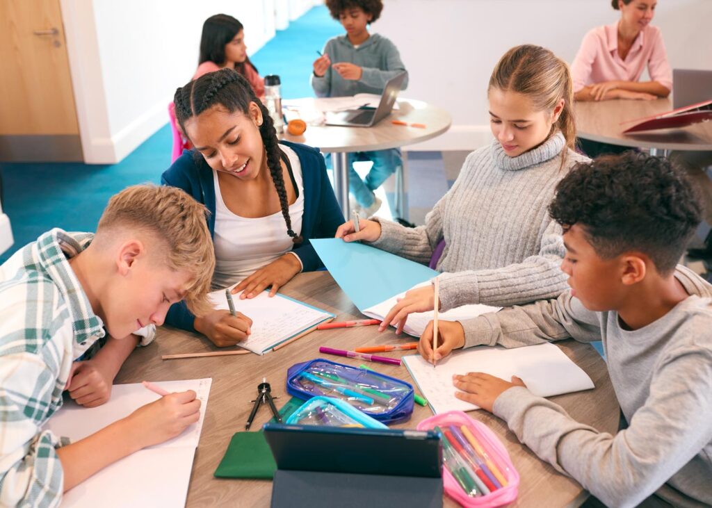 A group of students sitting together and working on their school work